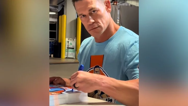 John Cena doesn't even need to look when signing autographs