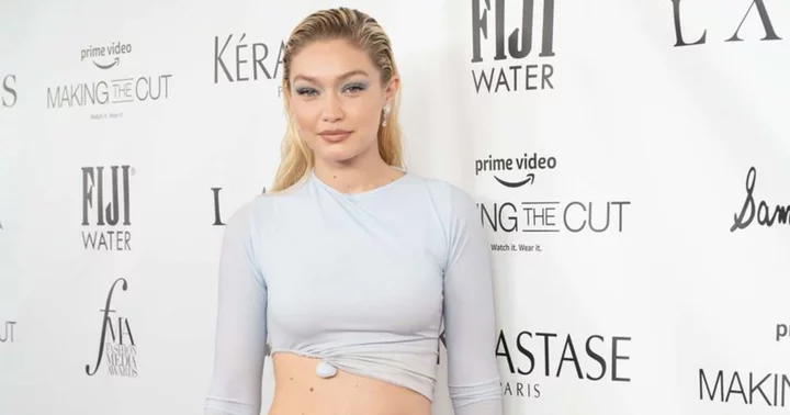 Gigi Hadid flaunts toned abs in black crop top and denim shorts during stroll through NYC with pal