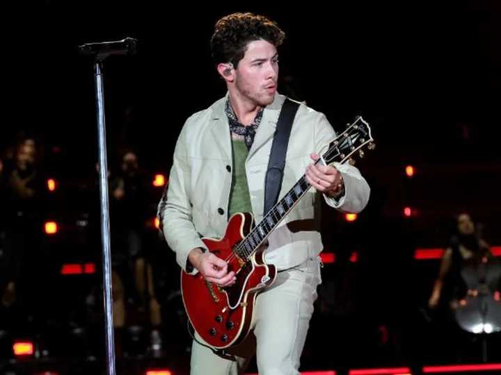 Nick Jonas plays it 'cool' after tumbling into a hole on stage during Boston concert