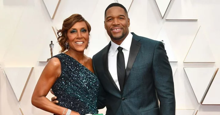 'GMA' host Robin Roberts interrupts live broadcast as she cuts off co-host Michael Strahan to fix her hair