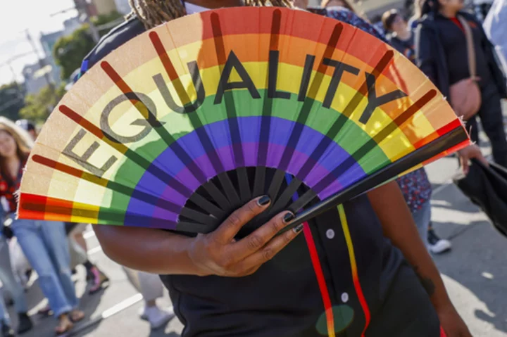 LGBTQ+ Pride revelers flash feathers and flags in the streets from New York to San Francisco
